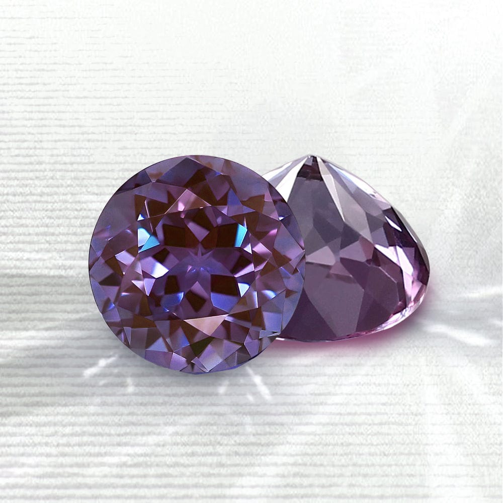 Two alexandrite gemstones on a white background