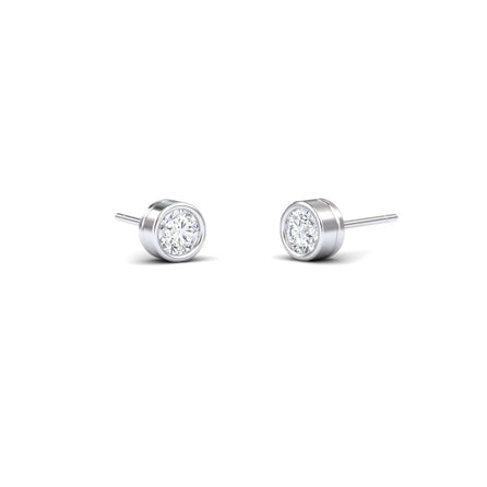 A pair of Lab Diamond Earrings - Bezel Set - Ishanvi, featuring round clear lab diamonds in sleek silver bezels, displayed on a plain white background.