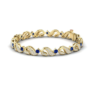 The Blue Sapphire & Diamond Swirl Link Bracelet - Elizabeth features wavy gold links with small white diamonds and round blue sapphires, secured with a sturdy clasp.