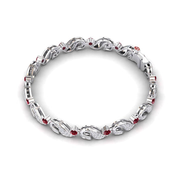 The Ruby & Diamond Swirl Link Bracelet - Elizabeth features an intricate silver design with alternating sparkling white diamonds and red rubies in an elegant, looped pattern.