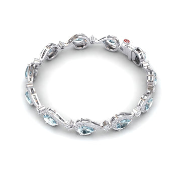 The Aquamarine & Diamond Tennis Bracelet - Gemma features oval-shaped aquamarines surrounded by sparkling diamonds in a repeating silver setting, displayed on a white background.