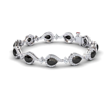 The Black & White Diamond Tennis Bracelet - Gemma features oval black gemstones framed by clear stones in a wavy, elegant pattern, with a secure clasp and sophisticated polished design.