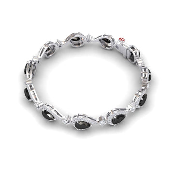 The Black & White Diamond Tennis Bracelet - Gemma features alternating black oval and round clear stones in an intricate silver linked design with a secure clasp.