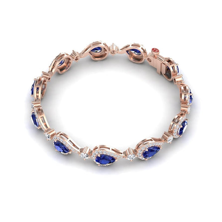The Blue Sapphire & Diamond Tennis Bracelet - Gemma features oval blue sapphires and small white diamonds in an elegant, repeating pattern, shown against a white background.