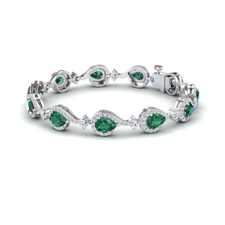 The Emerald & Diamond Tennis Bracelet - Gemma showcases alternating oval and pear-shaped green gemstones, each encircled by sparkling diamonds, linked in an elegant, flowing design.