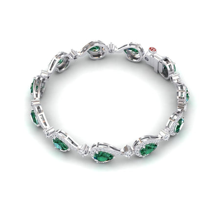 The Emerald & Diamond Tennis Bracelet - Gemma showcases oval green gemstones framed by white diamonds in a continuous silver design, displayed on a white background.