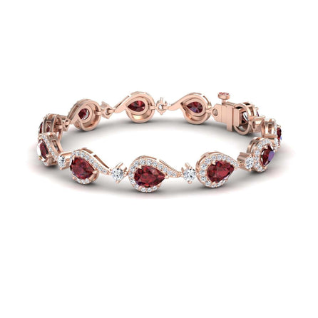 The Ruby & Diamond Tennis Bracelet - Gemma is a rose gold bracelet with pear-shaped rubies accented by sparkling diamonds, linked in an elegant pattern and secured with a clasp.