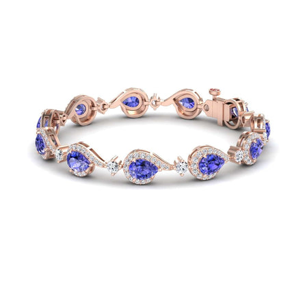 The Tanzanite & Diamond Tennis Bracelet - Gemma features oval blue gemstones, each encircled by sparkling diamonds, set in rose gold and linked in an elegant, repeating pattern with a secure clasp.