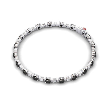 The Black & White Diamond Tennis Bracelet - Natalia features alternating round black and clear gemstones set in silver, evenly spaced along the length, and finished with a sleek clasp.