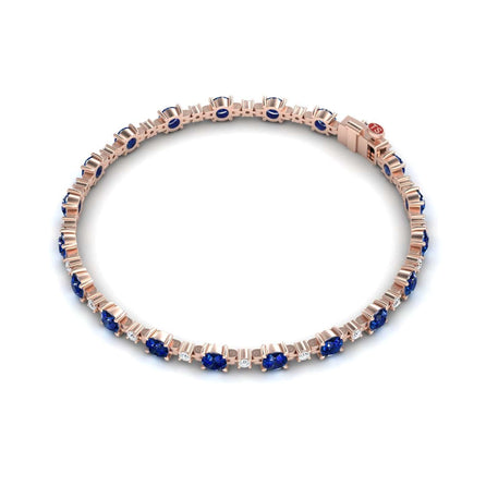 The Blue Sapphire & Diamond Tennis Bracelet - Natalia features alternating round blue sapphires and small white diamonds set symmetrically in a rose gold band.