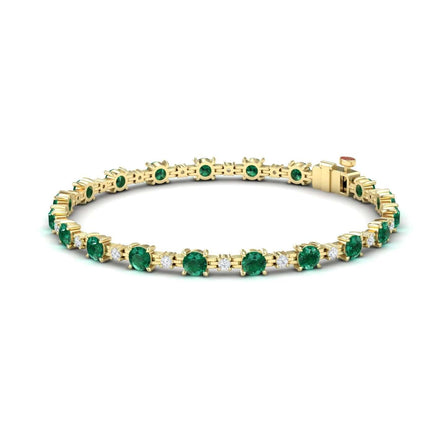 The Emerald & Diamond Tennis Bracelet - Natalia features a row of round green gemstones in prong settings and secures with a box clasp.
