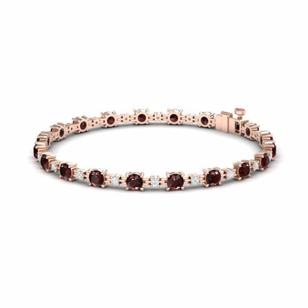 The Garnet & Diamond Tennis Bracelet - Natalia features round, deep red garnets set in a single row with prong settings and a secure clasp in rose gold.