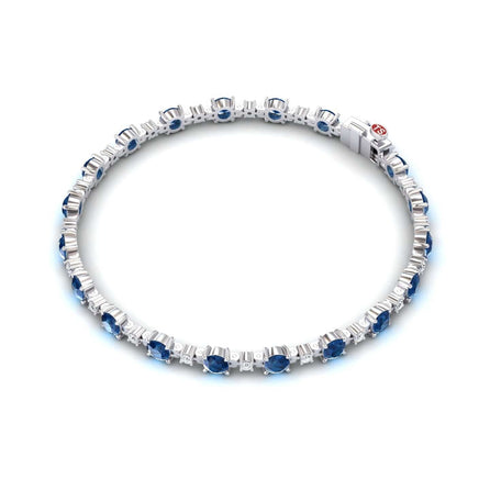 The London Blue Topaz & Diamond Tennis Bracelet - Natalia features evenly spaced round blue topaz gemstones and sparkling diamonds, all set in silver with a secure clasp.