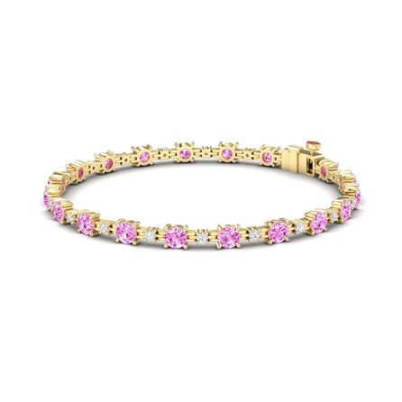 The Pink Sapphire & Diamond Tennis Bracelet - Natalia features round pink sapphires set in prongs, evenly spaced around the gold band, and secured with a reliable clasp.