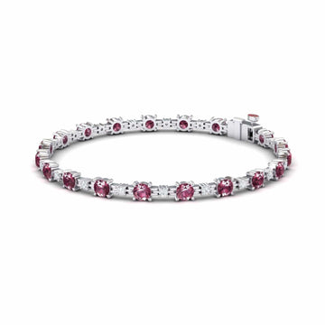 The Pink Tourmaline & Diamond Tennis Bracelet - Natalia features a row of round pink tourmalines set in prongs, finished with a secure clasp on the right.