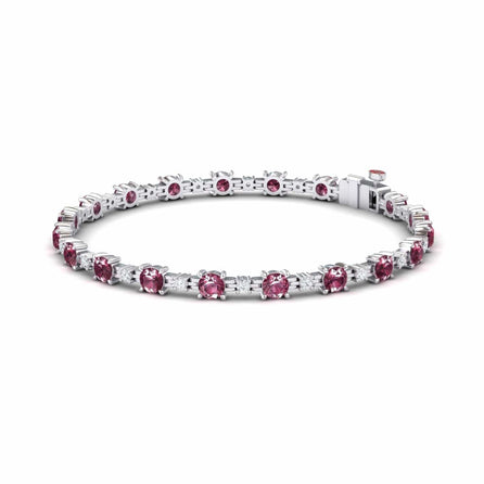 The Pink Tourmaline & Diamond Tennis Bracelet - Natalia features a row of round pink tourmalines set in prongs, finished with a secure clasp on the right.