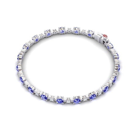 The Tanzanite & Diamond Tennis Bracelet - Natalia features alternating round blue tanzanites and white diamonds, a secure clasp, and a small red accent near the closure.