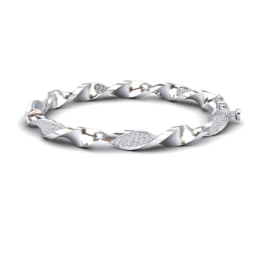 The White Diamond Twisted Bangle Bracelet - Dakota features a modern, elegant twisted design with alternating smooth and textured, glittering sections.