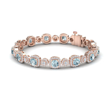 The Aquamarine & Diamond Tennis Bracelet - Erina features round aquamarine stones encircled by white diamonds in a rose gold setting, finished with a secure clasp.