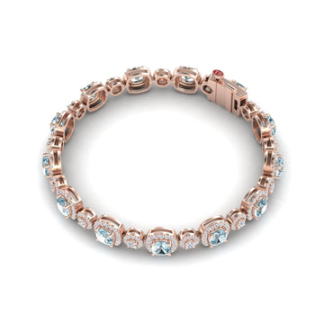 The Aquamarine & Diamond Tennis Bracelet - Erina showcases round aquamarines in individual links, each accented with sparkling diamonds, all displayed on a white background.