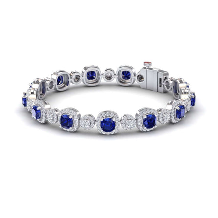 The Lab Grown Blue Sapphire & Diamond Tennis Bracelet - Erina features alternating round blue sapphires and diamond clusters in a secure, elegant, and symmetrical design that showcases the gemstones in a continuous loop.