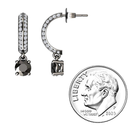 The Black & Diamond Pave Drop Hoop Earrings - Serena, featuring black stones and clear crystals, are shown beside a 2020 US dime for size comparison. These small hoops offer a modern, sparkly design.