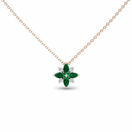 The Emerald & Diamond Flower Necklace - Keira features a gold chain and a flower-shaped pendant with alternating marquise-cut green emeralds and round white diamonds.
