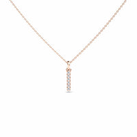 The White Diamond Vertical Bar Necklace - Lalita features a delicate gold chain and a vertical bar pendant set with five sparkling white diamonds in a row, displayed against a plain white background.