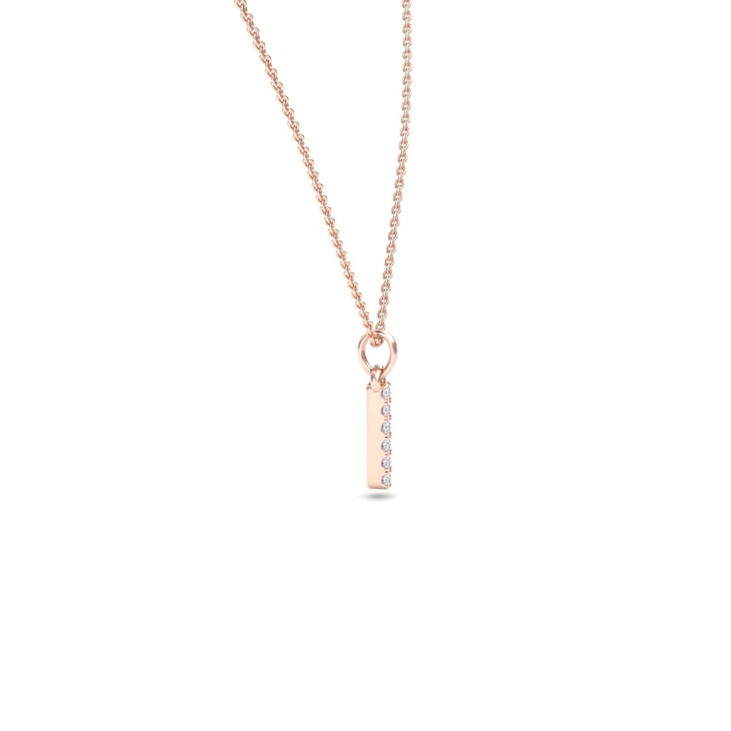 The Lalita White Diamond Vertical Bar Necklace features a delicate rose gold chain and a rectangular pendant adorned with a vertical row of sparkling white diamonds, displayed on a plain white background.