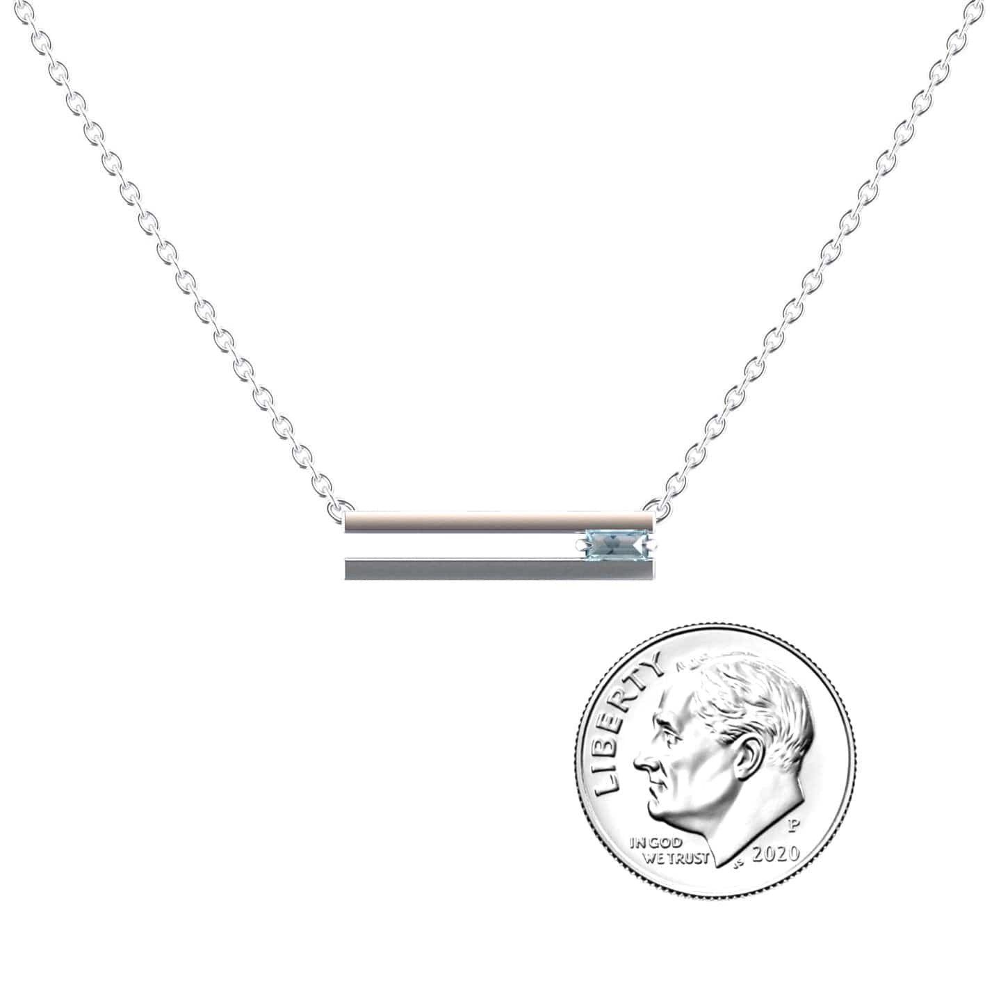 The Aquamarine Bar Necklace - Cecilia is a delicate silver bar necklace with a small aquamarine gemstone, shown beside a 2020 U.S. dime for size comparison on a plain white background.