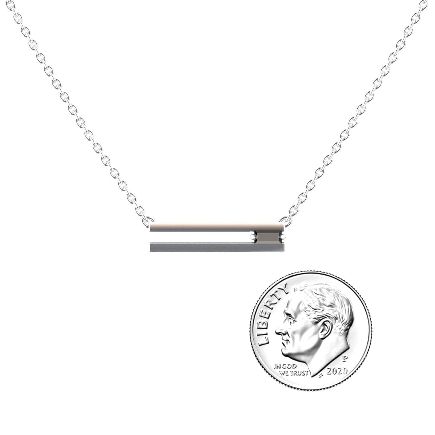 The Black Diamond Bar Necklace - Cecilia features a delicate silver chain with a horizontal bar pendant, set with a small black diamond. Shown next to a U.S. dime for size, this minimalist necklace highlights understated elegance.