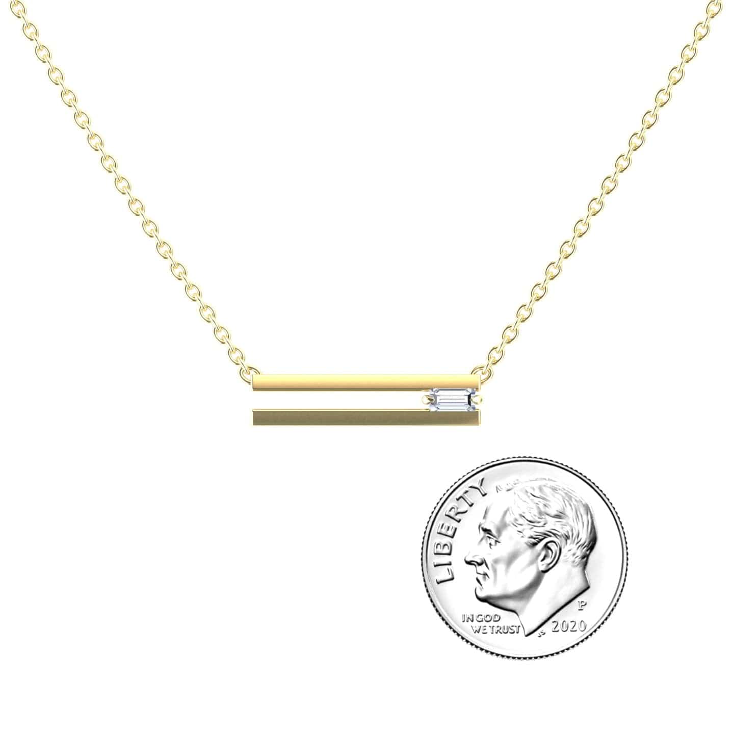 The White Diamond Bar Pendant - Cecilia features a gold chain with a horizontal gold bar and a small clear stone, shown next to a 2020 U.S. dime for size reference.