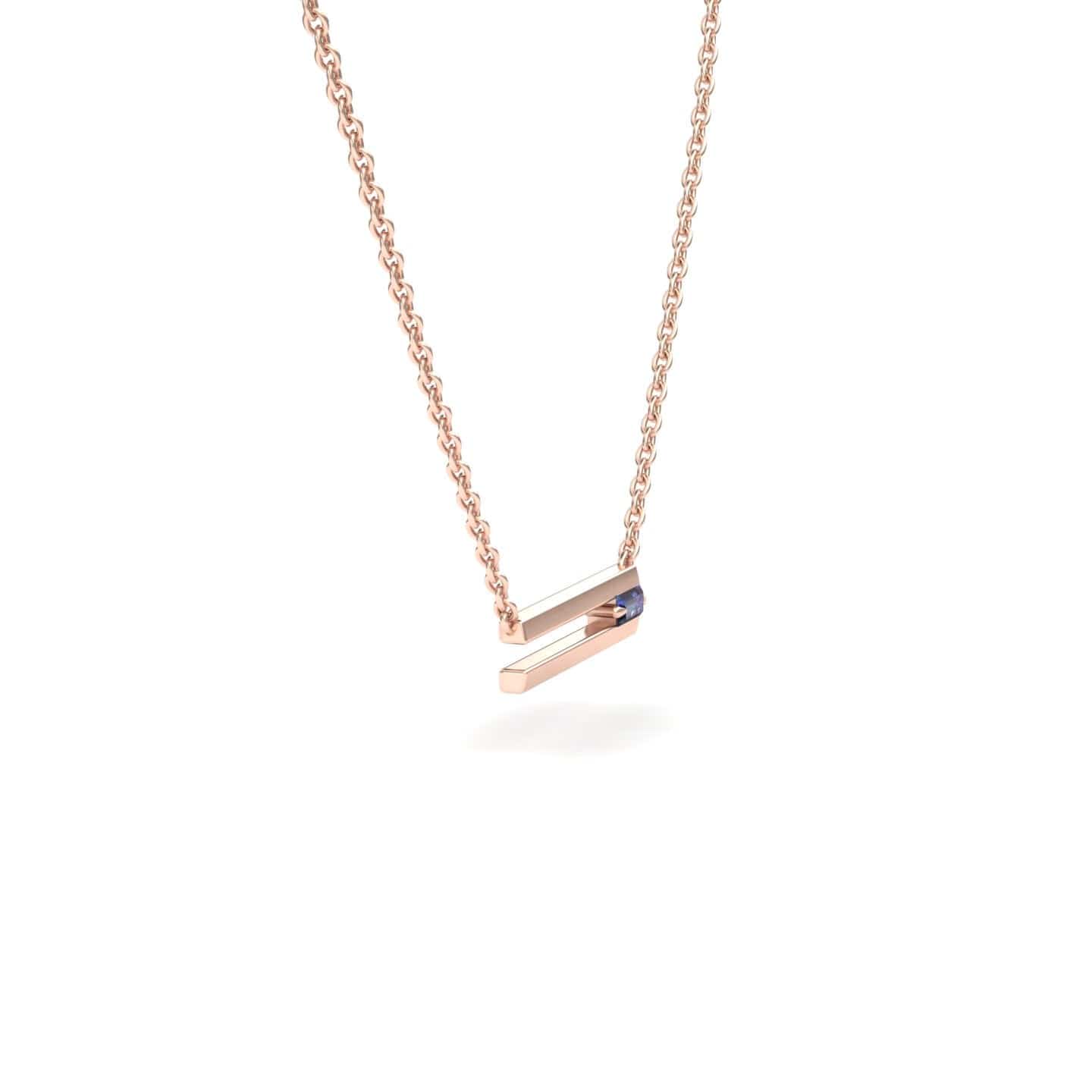 The Lab Grown Alexandrite Bar Necklace - Cecilia features a rose gold chain with a sleek, angled bar pendant and an embedded blue gemstone, shown on a white background.