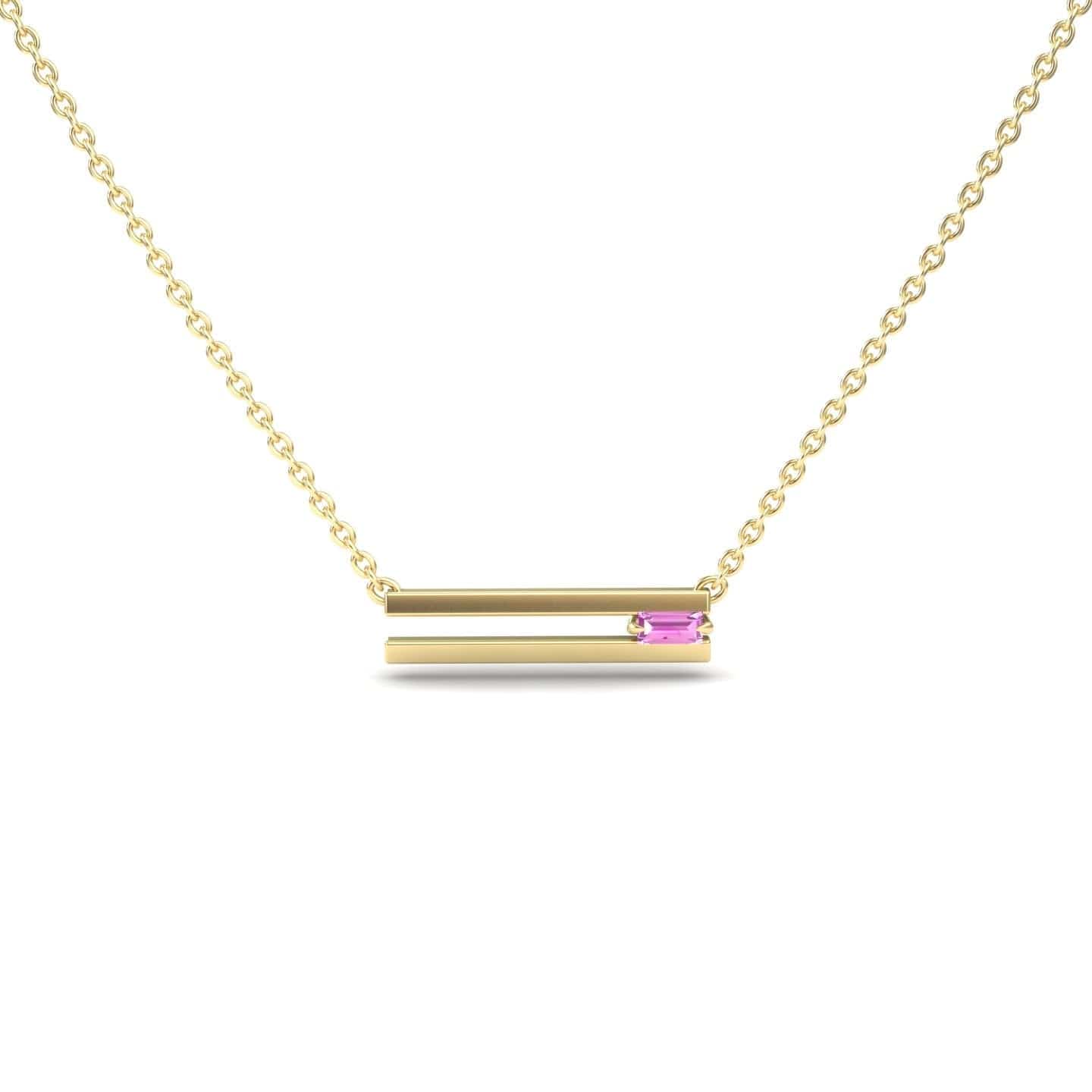 The Pink Sapphire Bar Necklace - Cecilia features a minimalist gold chain with a horizontal double bar pendant, one accented by a small pink sapphire. Its simple and elegant design stands out against a white background.