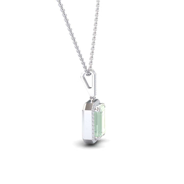 The Green Amethyst & Diamond Halo Necklace - Sanya features a rectangular pale green gemstone pendant set in silver, accented with diamonds, and hangs from a delicate chain against a white background.