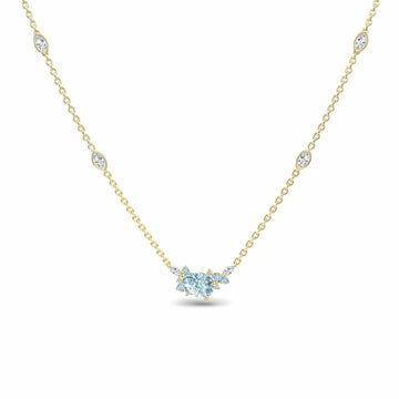 The Aquamarine & Diamond Bouquet Necklace - Daria features a delicate gold chain with a central cluster of sparkling marquise and round diamonds, accented by small diamonds spaced along the chain.
