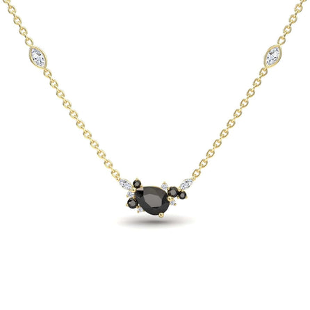 The Black & White Diamond Bouquet Necklace – Daria features a gold chain with a central oval black gemstone, surrounded by black and white stones, plus two marquise-shaped white stones set along the chain.