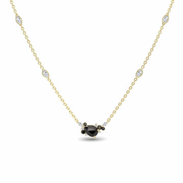 The Black & White Diamond Bouquet Necklace - Daria showcases a delicate gold chain with a central black gemstone encircled by white and black stones, plus four evenly spaced white stones along the chain.