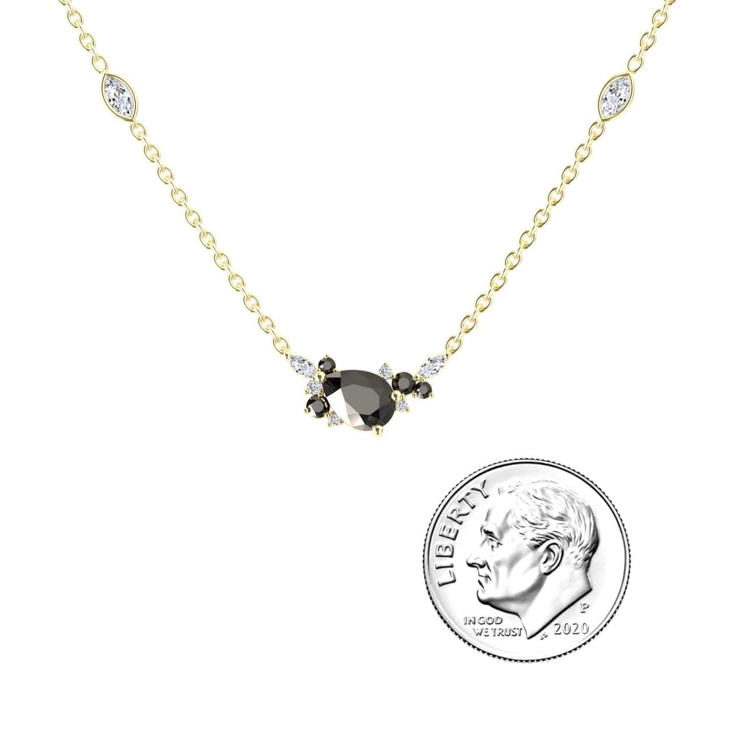 The Black & White Diamond Bouquet Necklace - Daria, featuring a central black gemstone accented by small white and black stones, is shown next to a 2020 US dime for size comparison.