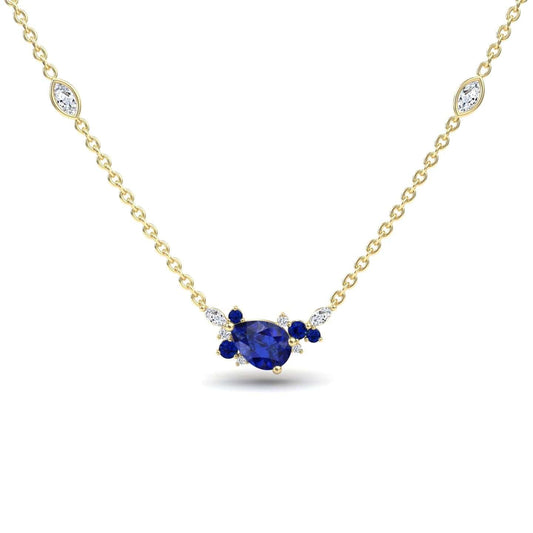 The Blue Sapphire & Diamond Bouquet Necklace - Daria features a gold chain with a central pear-shaped blue gemstone, accented by small blue and white stones and two marquise-cut white stones along the chain.