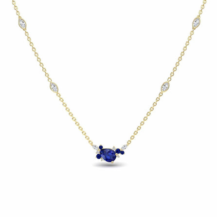 The Blue Sapphire & Diamond Bouquet Necklace - Daria features a central oval blue sapphire flanked by smaller sapphires and diamonds, with additional small diamonds set along its elegant gold chain.