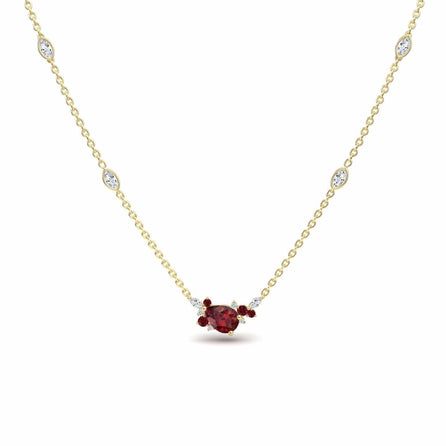 The Ruby & Diamond Bouquet Necklace - Daria showcases a central red gemstone encircled by smaller red and clear stones, with more sparkling clear stones set along its elegant gold chain.