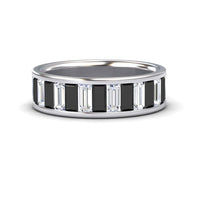 The Kyra Black & White Diamond Channel-Set Eternity Band is a silver ring with alternating rectangular black and clear baguette-cut stones in a continuous pattern around the band.