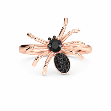 The Black Diamond Spider Statement Ring - Ainsley is a rose gold ring with black gemstones forming the spiderโs body and head, showcased against a white background.