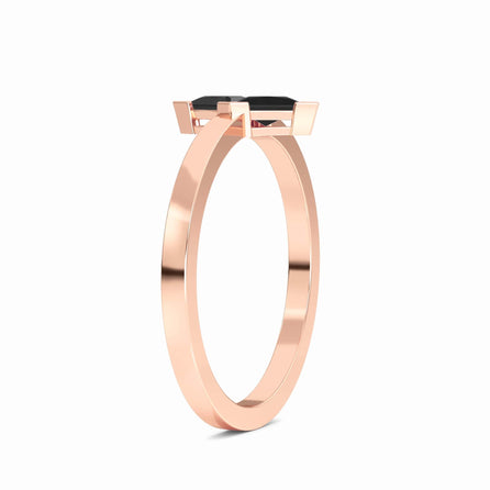The Black Diamond Triangle Statement Ring - Shalini features a sleek rose gold band with a modern prong setting showcasing a striking triangular black gemstone, displayed on a white background.