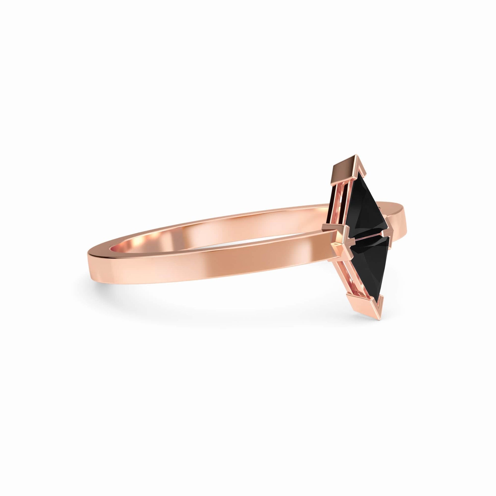 The Black Diamond Triangle Statement Ring - Shalini features a geometric black diamond set in a minimalist, angular prong rose gold band against a white background.