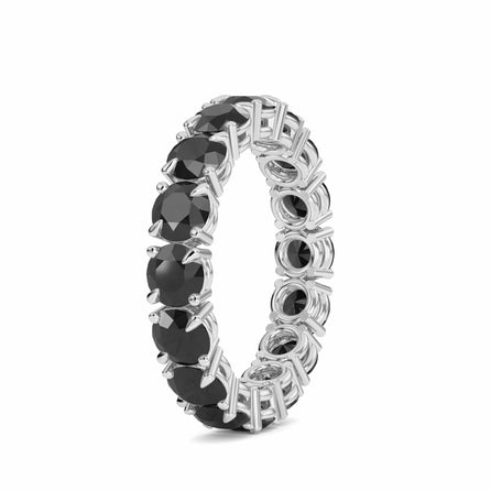 The Black Diamond Prong Set Eternity Band - Mehak features large round black gemstones set in prongs encircling the silver band, shown against a white background.