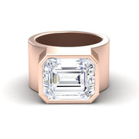 The Moissanite Statement Ring - Aparna features a wide rose gold band with a large, emerald-cut moissanite in a sleek flat bezel setting. The bold, smooth band highlights the modern geometric lines of the gemstone.