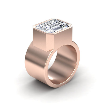 The Moissanite Statement Ring - Aparna features a wide rose gold band and a large, emerald-cut clear gemstone in a chunky bezel setting, shown on a white background.