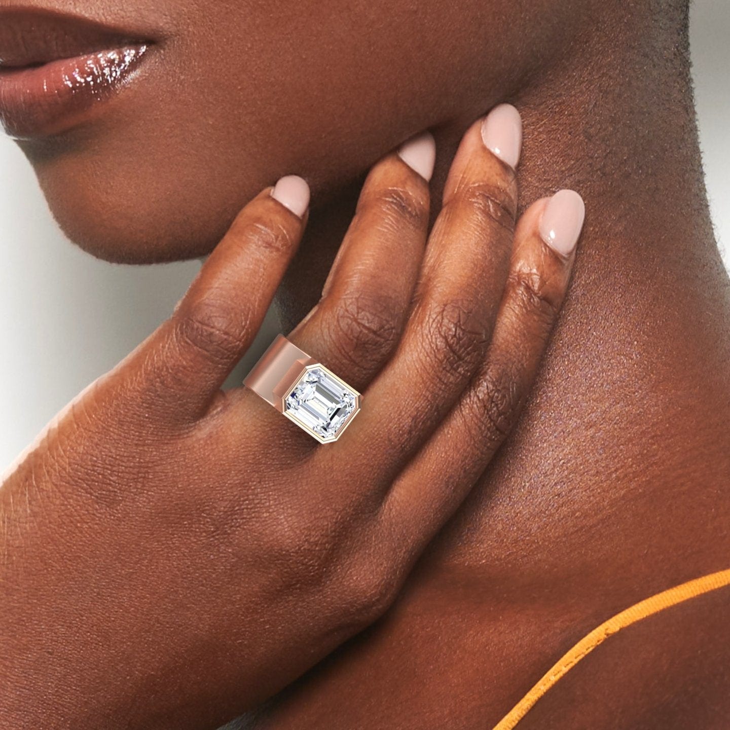 A close-up of a womans hand with light pink nails gently touching her neck, highlighting the Moissanite Statement Ring - Aparna, featuring a large emerald-cut stone on her finger.